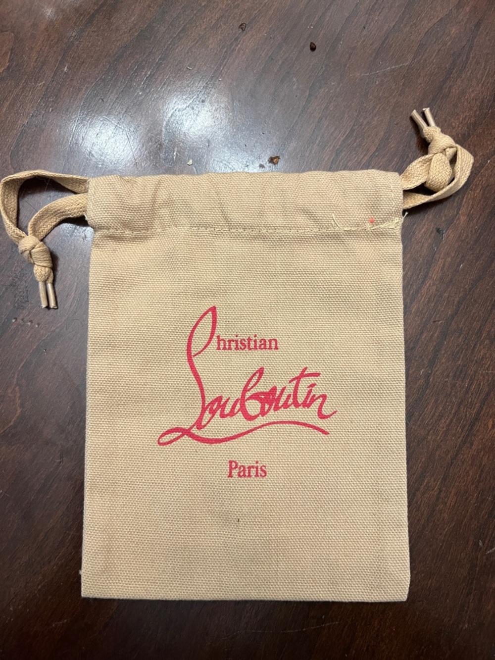 Christian Louboutin tan canvas drawstring pouch with red logo
